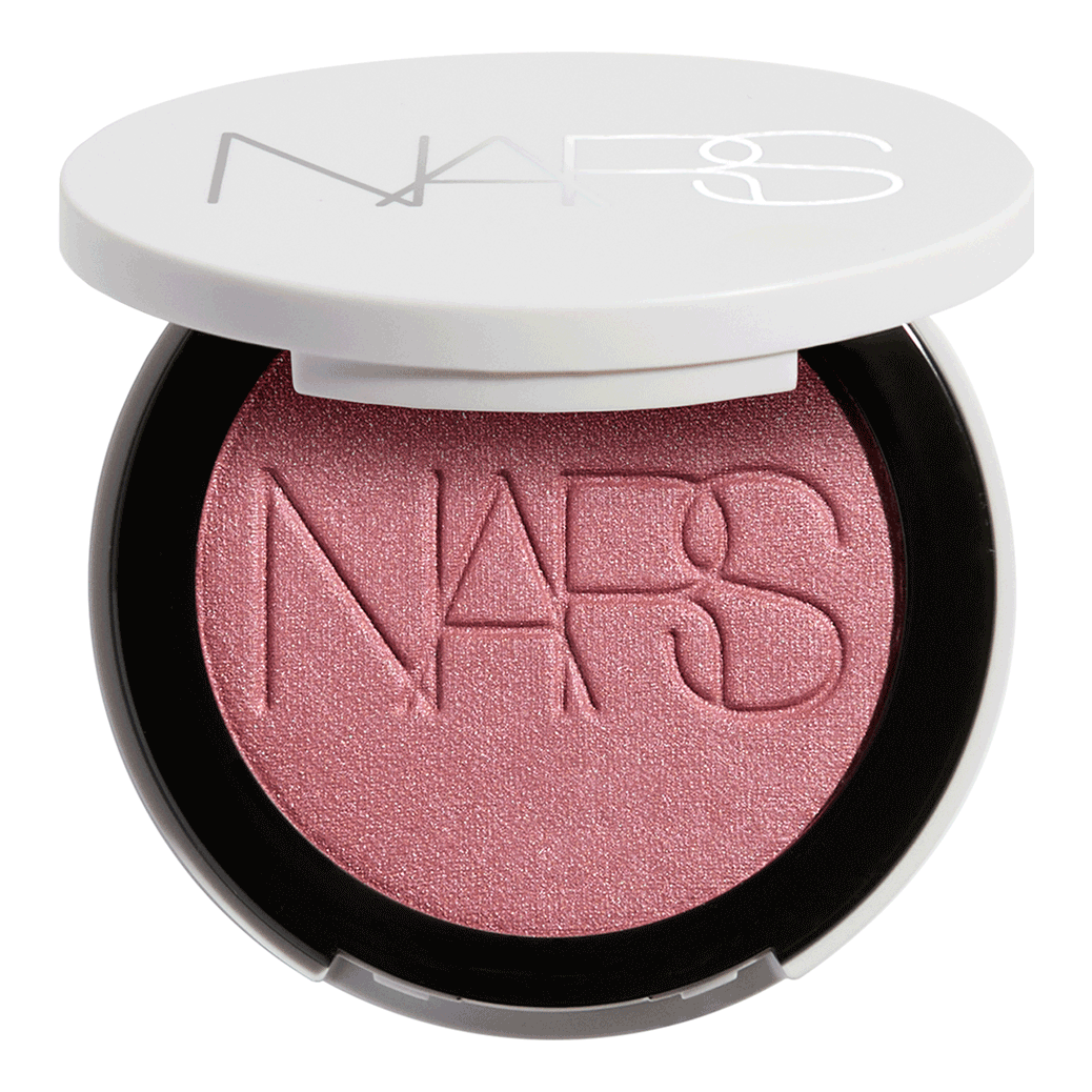 Nars Light Reflecting Blush - Nars - Duty Free - תפסי את האור. בצבע. מרחי ברק סוריאליסטי עם Light ReflectingTM Luminizing Blush, סומק פנינתי המעיר את הלחיים בפרץ של זוהר. פורמולה משיית וחושית המשלבת את אפקט